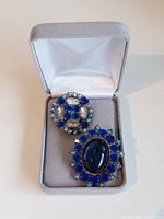 Two Czech glass rhinestone buttons in grey jewelry box