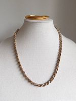 Necklace displayed on bust with bangles stacked above