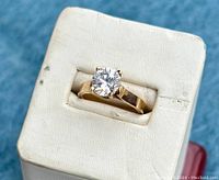 Top view of ring on display stand showing round cubic zirconia and four-prong setting