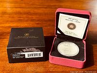 Photo of the black outer box labeled Royal Canadian Mint with barcode and lot sticker.