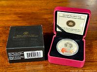 Photo of the silver coin in red clamshell box with certificate from Royal Canadian Mint