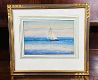 Full view of framed watercolor painting showing a sailboat on sea with multi-layered mat and gold decorative frame.