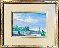 Framed watercolor painting depicting a landscape scene with trees and a cloudy blue sky, light wood frame with double matting.