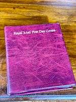 Burgundy textured binder embossed with 'Royal Mail First Day Covers' in gold lettering on the front cover.