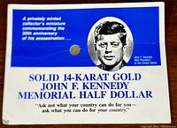 Photo of the commemorative card with miniature 14K gold JFK coin and standard half dollar for size comparison.