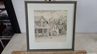 Full view of framed pen and ink drawing of residential streetscape.