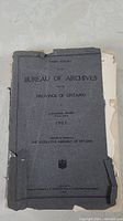 Front cover of the book showing the title 'Third Report of the Bureau of Archives Province of Ontario', author Alexander Fraser, and date 1905. Cover is grey with black text and significantly worn edges, with a piece missing from the bottom right corner.