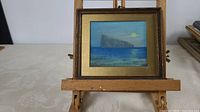 Frontal view of entire framed pastel painting on easel