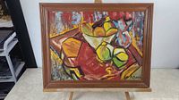 Framed original still life painting depicting fruit in a bowl on a table, colorful and vibrant composition