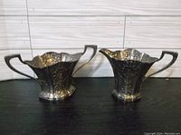 Full shot of both the cream pitcher and sugar bowl side-by-side showing size and shape.