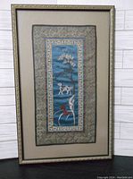 Full view of framed silk embroidered panel with visible mat and decorative frame.