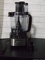Full view of Hamilton Beach food chopper with container and small accessory attached, showing overall condition and appearance.