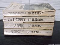 Stacked view of the 5 paperback books showing titles and author names on spines