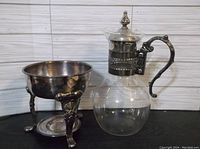 Wide view of the carafe and silverplate bowl showing overall condition and size.