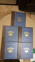 Five hardcover volumes with dark blue cloth covers and gold embossed titles from The Greatest Country Music Recordings of All Time by Franklin Mint Record Society.