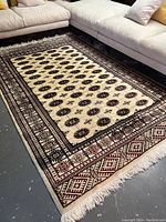 Full view of cream field and border, positioned under sectional sofa