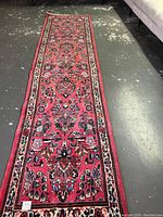 Full-length view of the rug showing overall design and condition