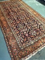 Full view of rug laid on concrete floor showing overall pattern and borders