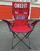 Front view of Cheez-It branded giant folding chair with Munch Mania design and two small basketball hoops on backrest.