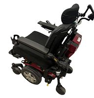 Full side view showing red frame, black seat, drive wheels