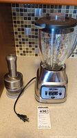 Photo showing Oster blender with glass pitcher and Norpro chopper on counter.