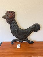 Full view of the carved wooden rooster wall hanging showing its standing base and detailed carving