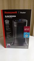 Front view of Honeywell slim design ceramic heater box showing product image and key features such as safety protection and compact size.