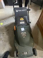 Top front view of Black & Decker electric lawn mower showing logo, model, and cut width.