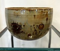 Front view of pottery bowl showing glaze texture and colors