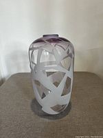 Front view of the pale purple glass vase showcasing the abstract sandblasted geometric pattern and smooth glass areas.