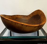 Side view of walnut bowl showing organic free-form profile and smooth finish