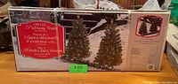 Box displaying 2 pack LED pathway trees with images of lighted trees on top of snow covered ground.