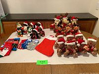 Wide shot of the entire collection featuring Christmas stuffed animals, holiday socks, gloves, and a large stocking arranged on a table with a countertop background.