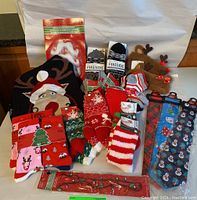 Photo shows the Christmas sweater, socks, ties, slippers, and holiday light decoration included in the lot