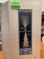 Box front shows images of two LED Christmas decorations, the focus on 51" 3D glittered silhouette tree with blue LED lights.