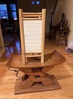 Wooden carved bench visible with curved seat and sturdy base, showing wood splitting.