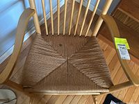 Close-up of woven rush seat showing fiber pattern and a small discoloration spot