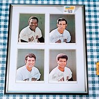 Front view of the framed set of four autographed photos showing the players George Scott, Bob Montgomery, Sonny Siebert, and Reggie Smith in their Boston Red Sox uniforms with signatures.