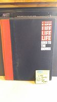 Front cover of the hardcover photo book titled 'LIFE GOES TO THE MOVIES' showing black cover with red spine and title lettering.