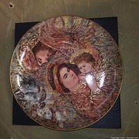Full view of signed Edna Hibel 'The Nativity' collectible plate showing detailed artwork of Mary, baby Jesus, and an angel with gold and blue accents.