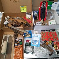 Full lot overview showing varied hand tools, electrical sockets, screws, and hardware arranged in boxes.