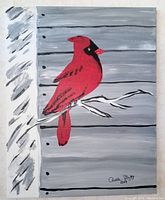 Full view of the canvas painting showing the red cardinal on a birch branch with grey wood panel background and artist's signature.