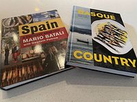 Two hardcover cookbooks on table, one "Spain" by Mario Batali and the other "Basque Country" by Marti Buckley