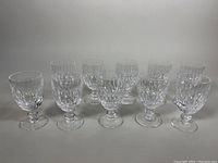 Ten glasses arranged in two rows on a neutral background