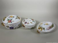 Set of three Royal Worcester Evesham lidded casserole dishes of different sizes, showing general appearance and color patterns.