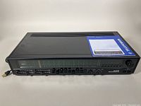 Front view of the vintage MCM Telefunken Opus HiFi 7050 stereo receiver with original manual placed on top.