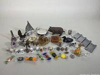 Full lot overview with all items displayed including paperweights, figurines, thimbles, and glass candies.