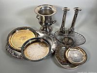 Full set of vintage silver plated pieces including ice bucket, candleholders, and multiple trays