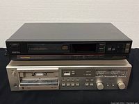 Front view showing TELEFUNKEN 1010 CD player stacked on top of DUAL C-822 cassette deck, indicating both items included in lot.