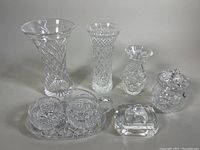 Full view of all crystal items including vases, sugar bowl set, tray, and square piece